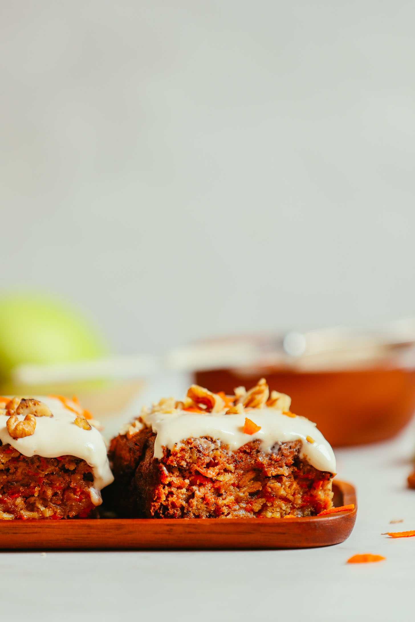 Slices of Carrot Apple Snack Cake resting on a wood platter