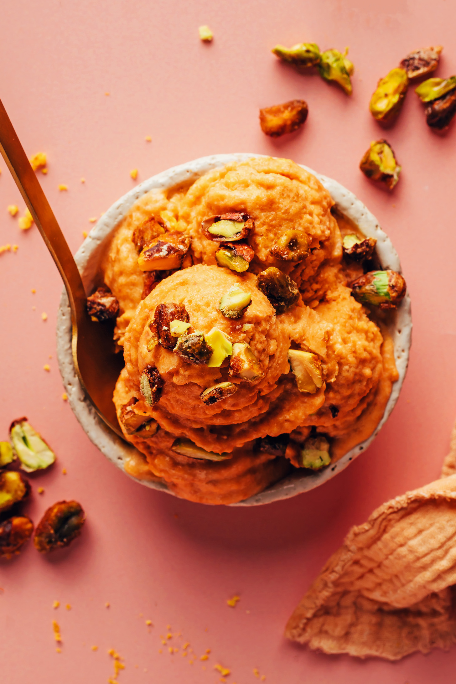 Bowl of apricot sorbet topped with candied pistachios