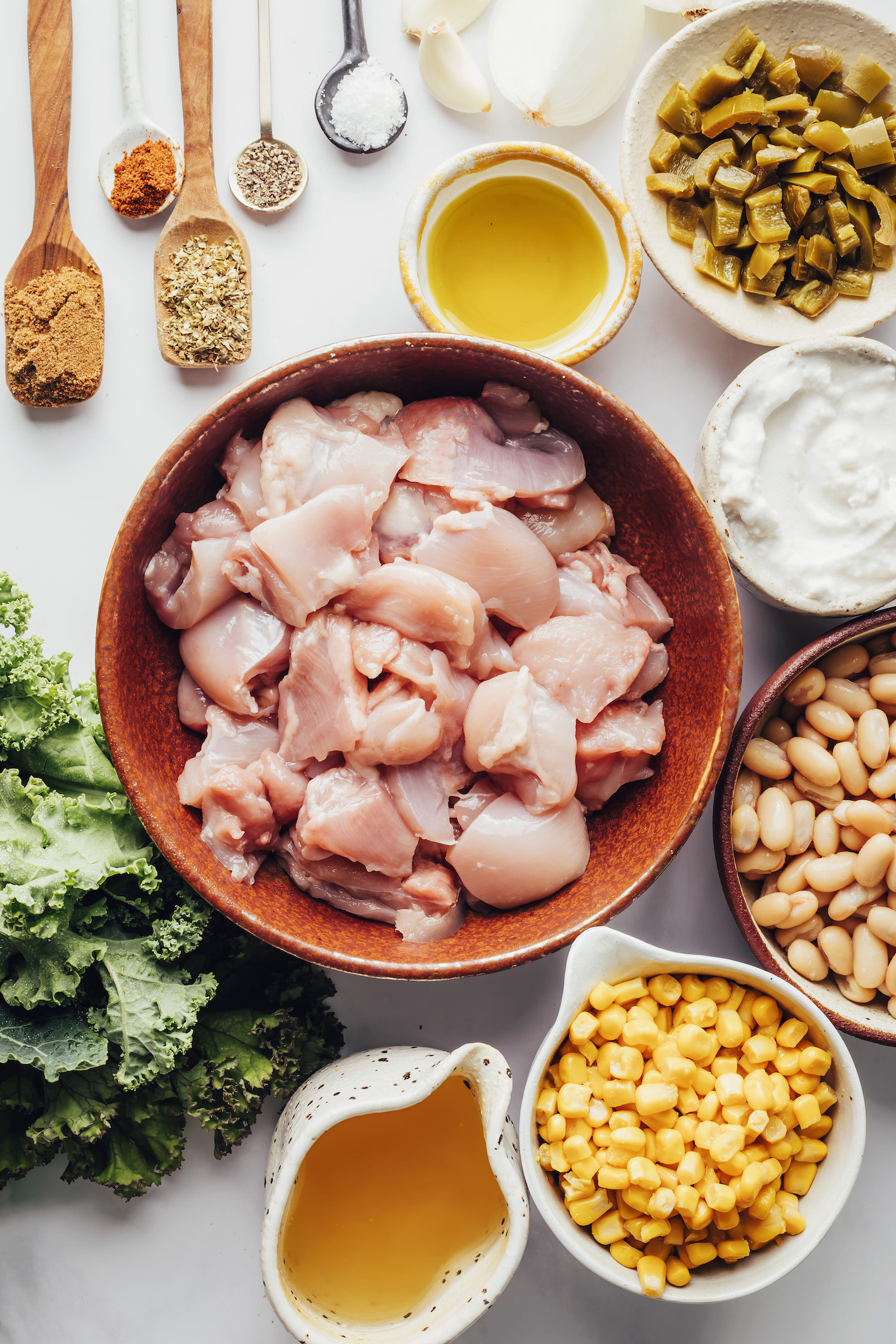 Spices, oil, chiles, coconut milk, white beans, corn, broth, chicken, and kale