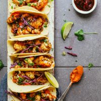 Display of healthy Roasted Cauliflower Tacos with Adobo Romesco for a healthy plant-based meal