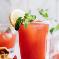 Glasses of homemade strawberry lemonade topped with fresh mint