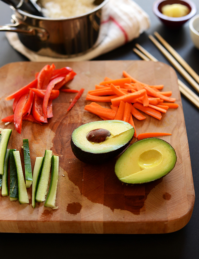 Cutting board with fresh vegetables for making homemade sushi