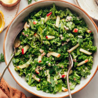 Servings spoons in a bowl of our simple kale apple slaw recipe