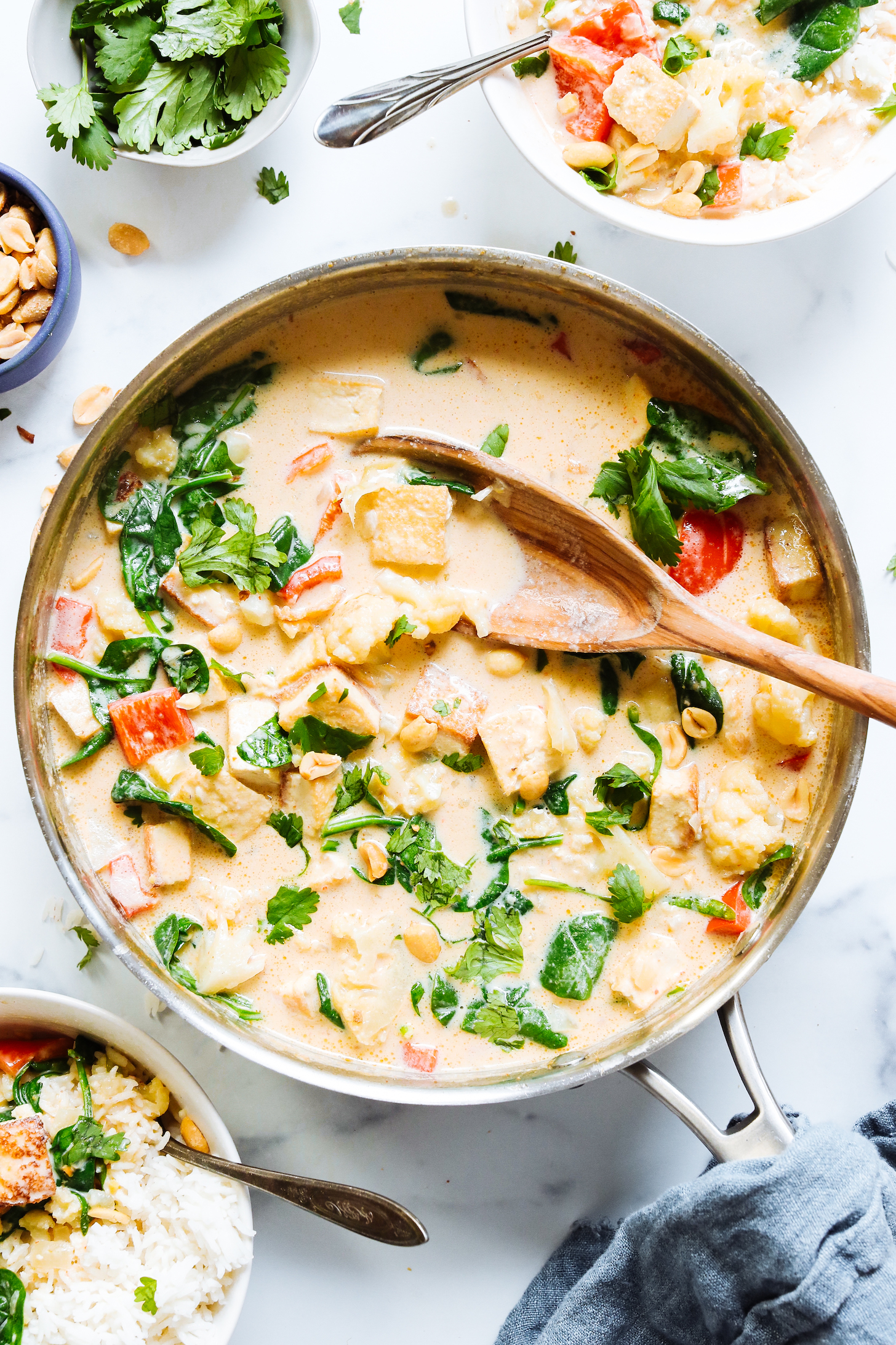 Pan of tofu vegetable panang curry sprinkled with peanuts