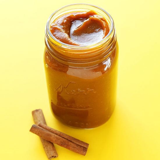 Cinnamon sticks beside a jar of homemade Pumpkin Butter