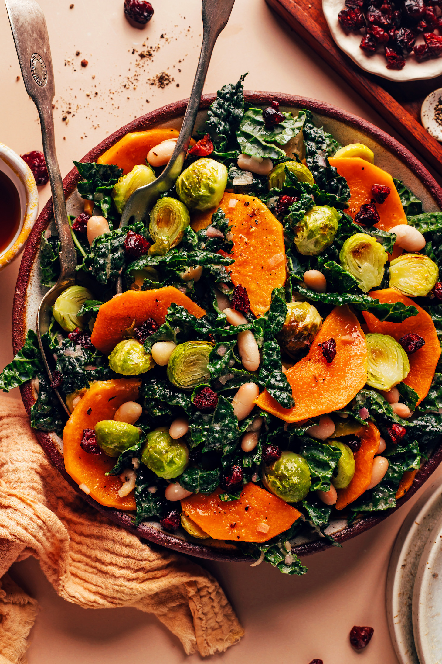 Serving fork and spoon in a bowl of our Roasted Fall Vegetable Salad with White Beans