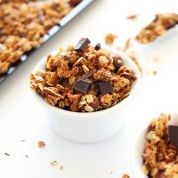 Bowls and baking sheet of homemade almond joy granola