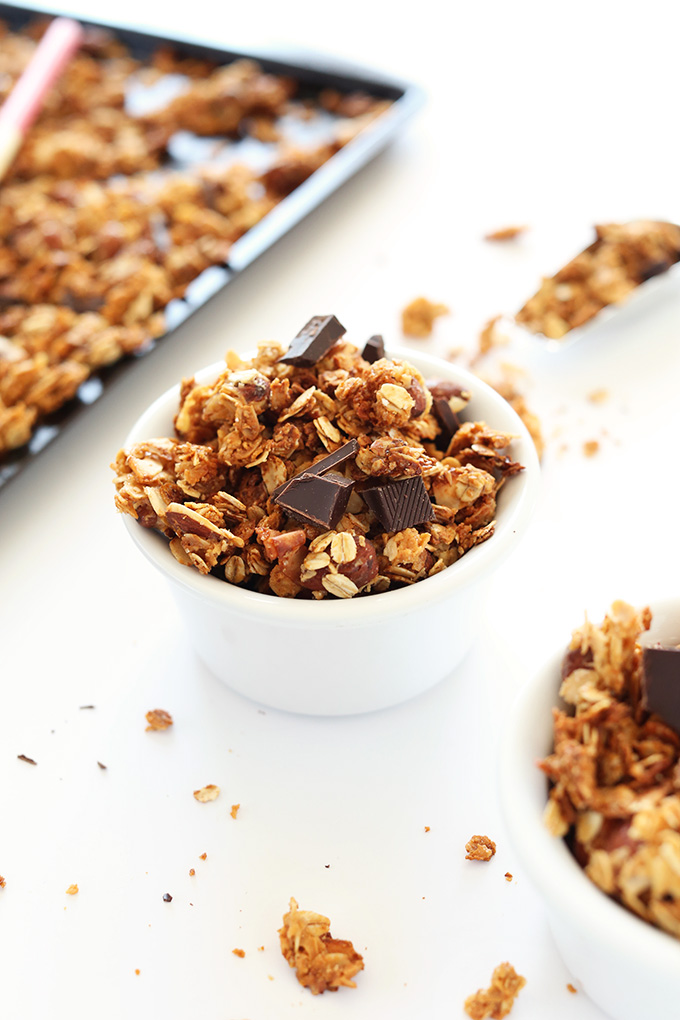 Bowls and baking sheet of homemade almond joy granola