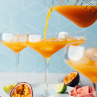 Pouring our spicy passion fruit mocktail into a glass