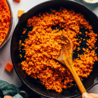 Sautéing sweet potato rice in a cast iron skillet