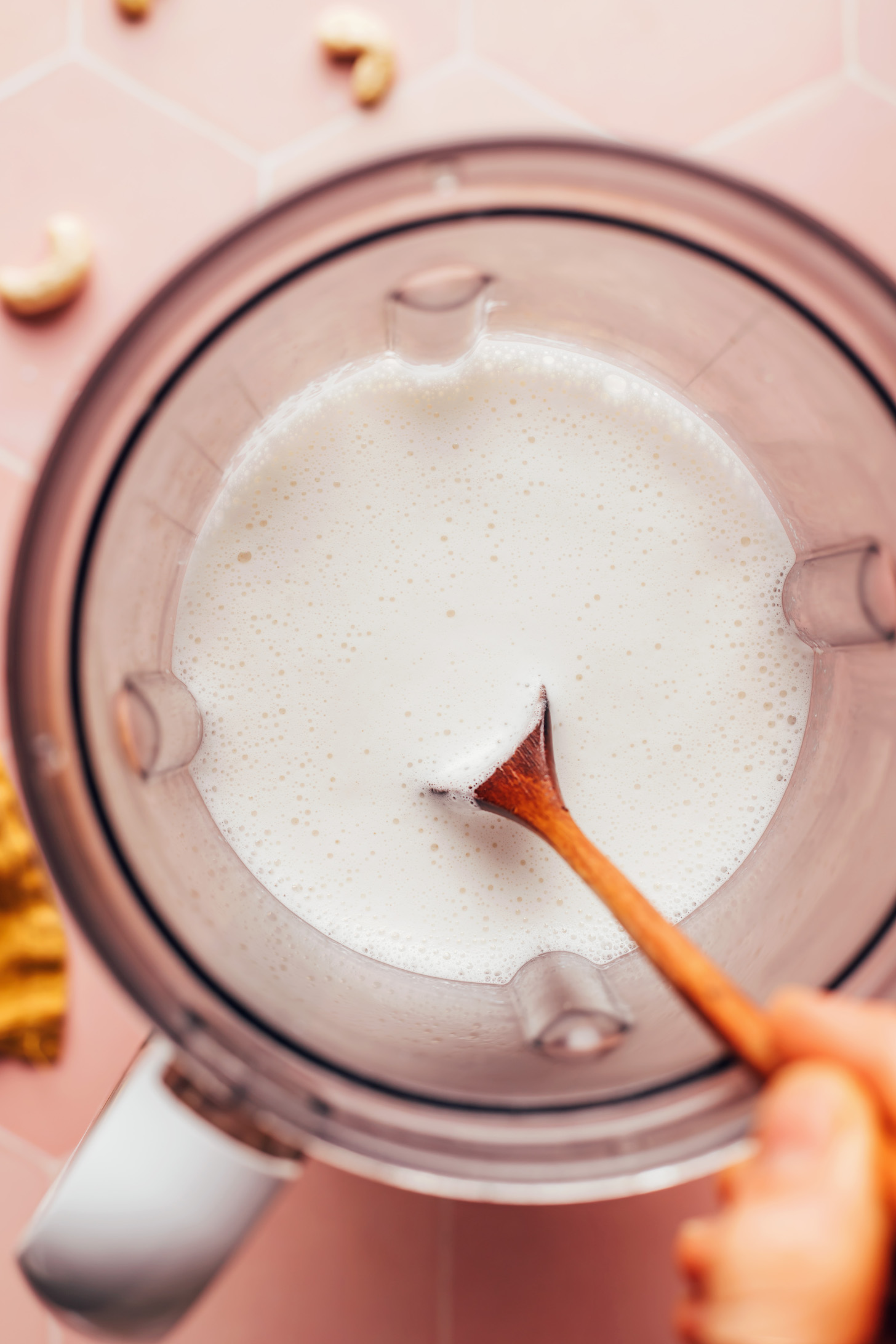 Stirring a creamy blended mixture in a blender