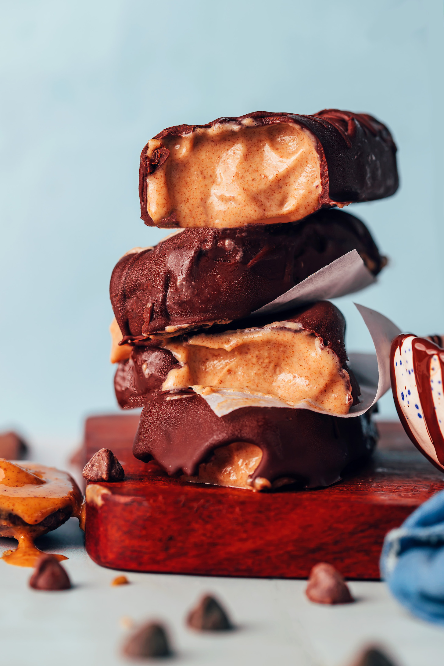 Stack of creamy vegan peanut butter ice cream bars coated in chocolate