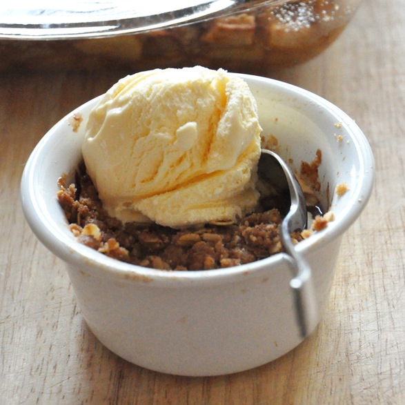 Ramekin of Gluten-Free Apple Crisp topped with vegan ice cream