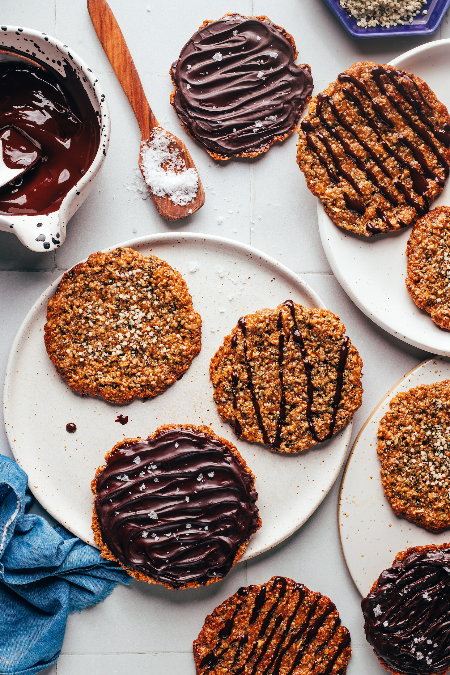 Plates of hemp seed Florentine cookies with some plain and others decorated with melted chocolate