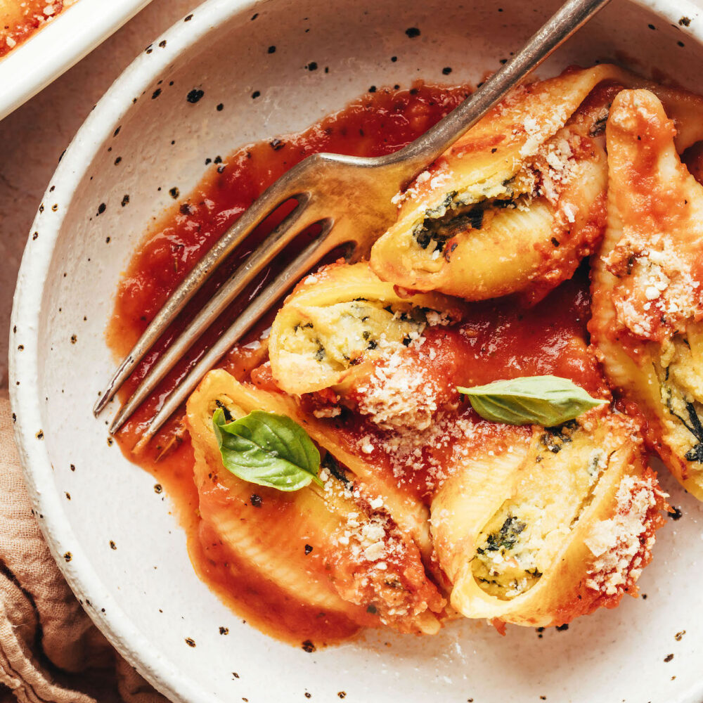 Fork in a bowl of vegan stuffed shells